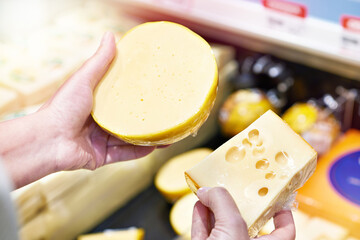 Buyer chooses cheese in store