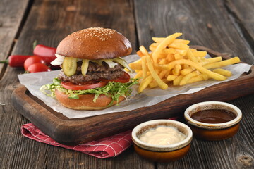 Tasty classic burger with crispy hamburger buns,ketchup, mayonnaise and french fries
