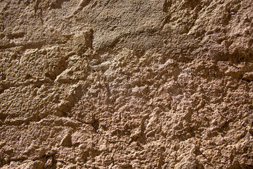 Stone antique old wall as a background or texture. Vintage background of a fortress wall in loft and grunge style with place for text and copy space.