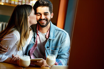 Romantic couple in cafe is drinking coffee and enjoying being together
