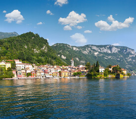 Fototapeta na wymiar Town on Lake Como coast (Italy). Summer view from ship board.
