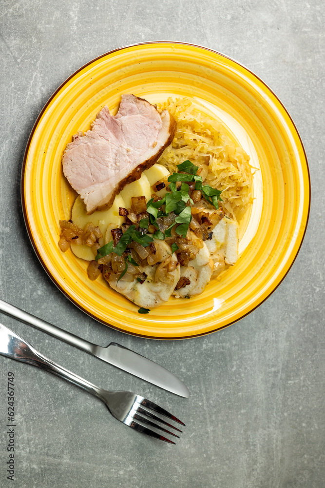 Wall mural pork meat with potato dumplings and pickled cabbage served with roasted onion