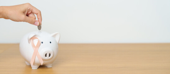 September Uterine Cancer Awareness month, Peach Ribbon with Piggy Bank for support illness life. Health, Donation, Charity, Campaign, Money Saving, Fund and World cancer day concept