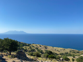 Gokceada (Imbros) coastline seashore view with Samothrace Greek island at background. Tepeköy village, Çınaraltı-Pinarbasi location, Aegean Turkey