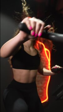 female running on elliptical orbitrek machine in fitness gym. Slow motion