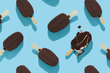 trendy seamless pattern of chocolate popsicle and damaged melted with ice cream and hard shadow on blue background, creative decoration of summer concept