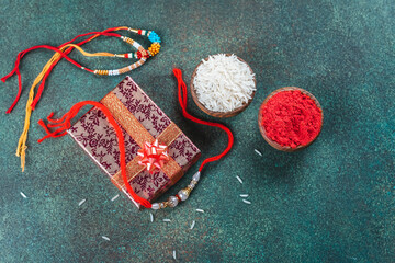 Raksha Bandhan background. Gift box and rakhi bracelet. Traditional Indian Holiday Festival Raksha...