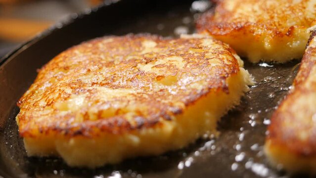 Potato pancakes frying on a pan. Closeup