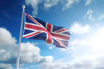 English flag flying in the wind on a flagpole against a blue sky with clouds. Blue red white United Kingdom of Great Britain flag wallpaper.  