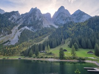 Fototapeta na wymiar Gosauseen Lake hike in Austria, Europe, surrounded by snowy mountains and autumn trees