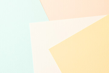 Rough kraft paper pieces collage background, geometric paper texture pastel colors. Mockup with copy space for text.