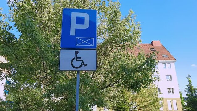 Road sign Parking only for disabled drivers on modern residential neighborhood background. Concept of Accessible Parking and locations. Adapted spaces for people with disabilities. Inclusion.