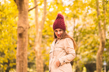 Portrait of woman in autumn next to a forest in nature