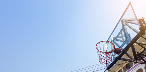 Basketball hoop and backboard with blue sky copy space