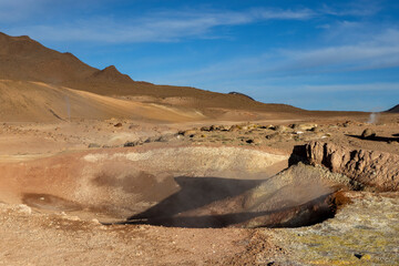 Stunning geothermic field of Sol de Mañana with its steaming geysers and hot pools with bubbling...
