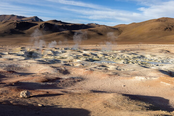 Fototapeta na wymiar Stunning geothermic field of Sol de Mañana with its steaming geysers and hot pools with bubbling mud - just one sight on the lagoon route in Bolivia, South America 
