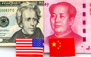 A 20 USD bill and a Chinese 100 Yuan bank note with the US and Chinese national flags isolated in...