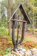 Wooden cross with the figure of Jesus Christ by the blue tourist trail from Rabka-Zdrój to Luboń Wielki in Beskid Wyspowy (Poland) on an autumn day