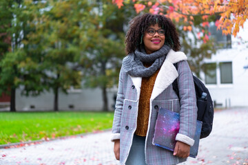 Black ethnic girl strolling in college college in fall back to school