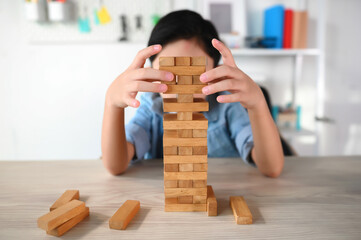 Child Boy Playing Jenga Game Exciting on Desk at Home. Careful and Attentive Keeping, Concentrate and Slowly Observing and Manage to Take It Out while Playing to Maintain Balance Objects.