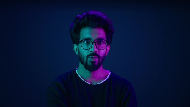 Male portrait neon background shocked amazed astonish wonder Indian man coder hacker computer technology worker guy looking in front futuristic high-tech software hologram mock up infographic backdrop