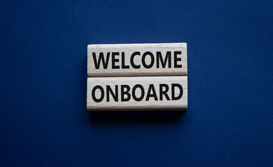 Welcome onboard symbol. Concept words Welcome onboard on wooden blocks. Beautiful deep blue background. Business and Welcome onboard concept. Copy space.