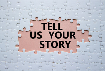 Tell us your story symbol. Concept words Tell us your story on white puzzle. Beautiful pink background. Business and Tell us your story concept. Copy space. - obrazy, fototapety, plakaty