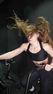female running on elliptical orbitrek machine in fitness gym. Slow motion