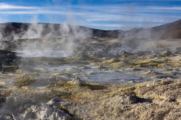 Stunning geothermic field of Sol de Mañana with its steaming geysers and hot pools with bubbling mud - just one sight on the lagoon route in Bolivia, South America