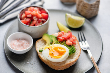 Bread toast with egg, tomato and boiled egg on plate, closeup view. Healthy vegan breakfast or lunch meal