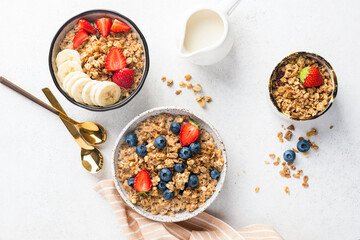 Breakfast oat granola bowl with fresh berries and oat milk, table top view, flat lay food photo composition