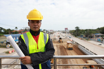 Portrait survey technician at new road construction site.