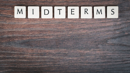 Back to school concept. Finals week word on wooden desk.