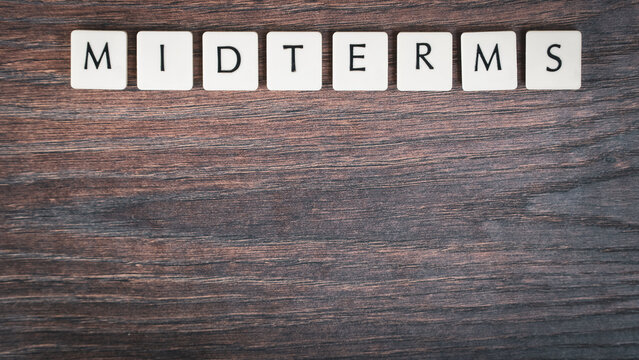Back to school concept. Finals week word on wooden desk.