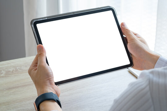 woman holding and showing a tablet with a white screen and empty items in hand And his screen is showing free copy space for your ads. Technology concept
