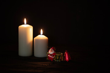 Burning candles and christmas decorations on a dark background