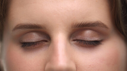 Close-up of closed female eyes of a beautiful woman.