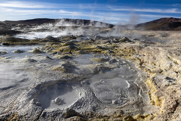Stunning geothermic field of Sol de Mañana with its steaming geysers and hot pools with bubbling mud - just one sight on the lagoon route in Bolivia, South America