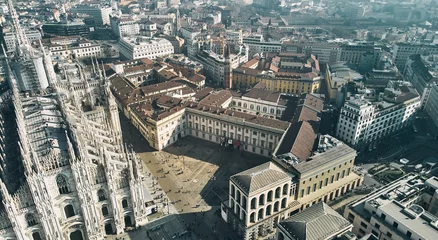 Foto op Plexiglas Aerial view of Piazza Duomo in front of the gothic cathedral in the center. Drone view of the gallery and rooftops during the day. Milan, Italy. High quality photo © Dima Anikin