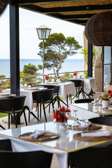 table and chairs in restaurant with a sea view