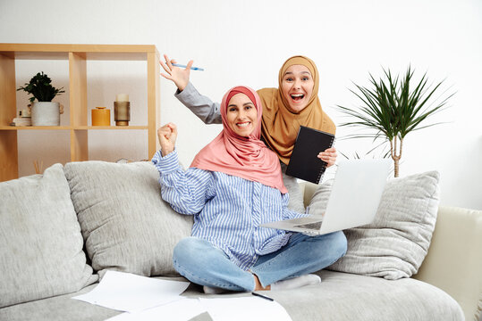 New job opportunity. Overjoyed Arabian women exclaims yes of good news and celebrating success, sitting with laptop at workplace at home office. Successful internship and training.