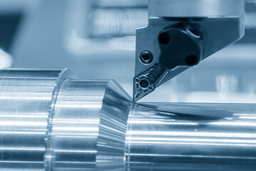 Close up  the metal shaft part and the lathe tool in the light blue scene.