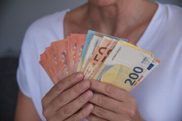 Close-up Of Person Hand Showing Euro bancnotes.