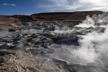 Stunning geothermic field of Sol de Mañana with its steaming geysers and hot pools with bubbling mud - just one sight on the lagoon route in Bolivia, South America