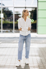 Young woman standing outside office building