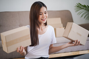 Asian woman preparing package delivery box Shipping for shopping online delivery mail service people and shipment concept