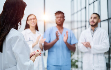 Fototapeta premium medic woman stands with her back and instructs with colleagues