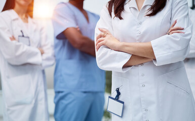 Group of medical staff in clinic hallway.