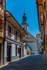 Fototapeta na wymiar A view up a deserted backstreet towards the cathedral in the old town of Skofja Loka, Slovenia in summertime 