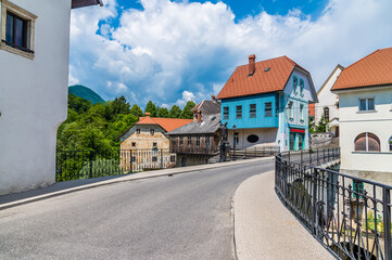 Naklejka na ściany i meble A view across the fourteenth century, Capuchin bridge in the old town of Skofja Loka, Slovenia in summertime 